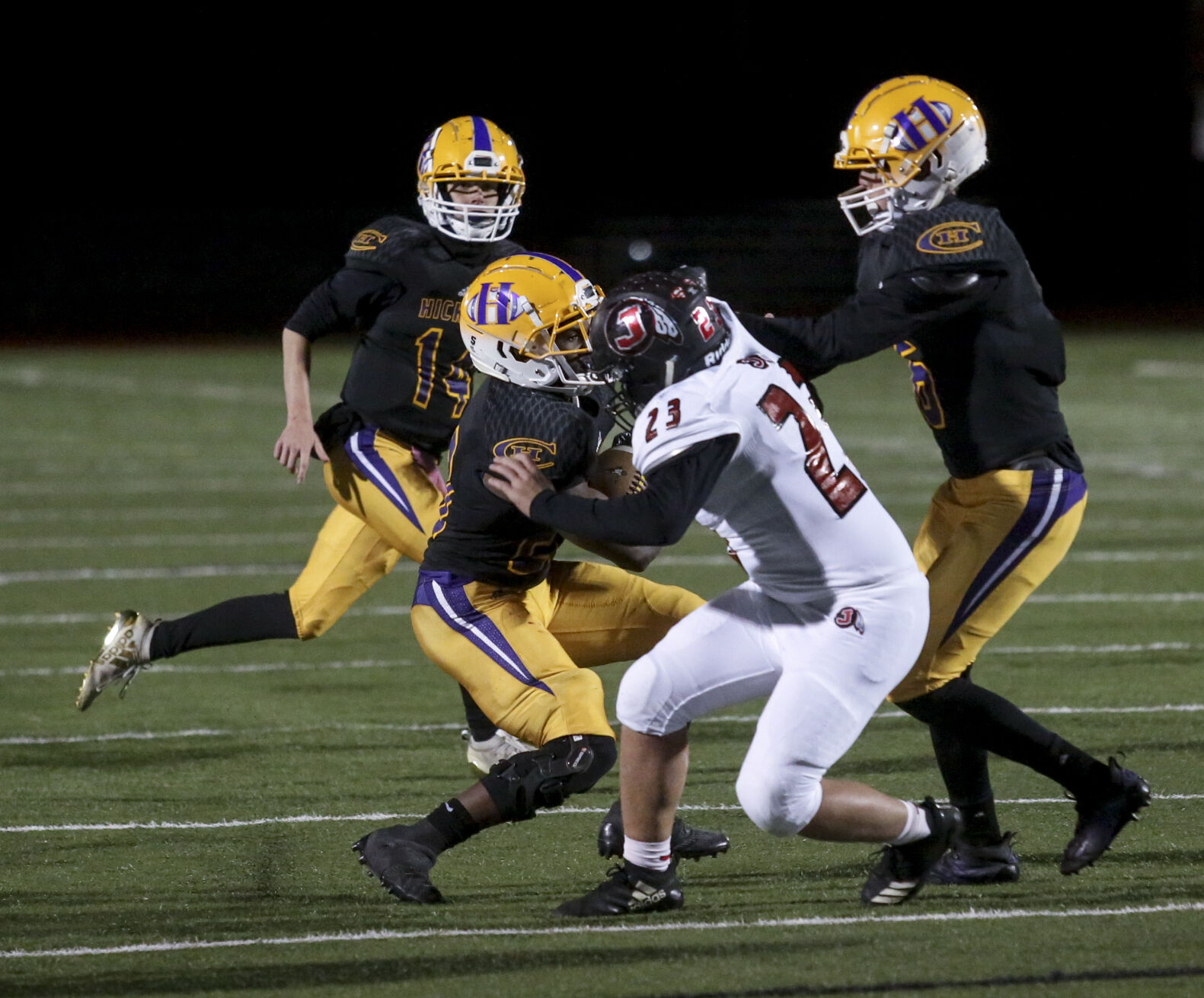 Hickman senior James Lober is tackled on a play by Jackson sophomore Griffin Horman